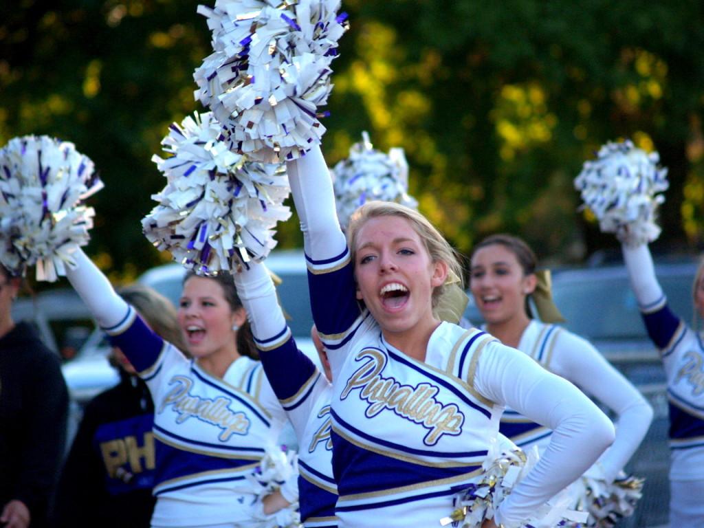 Senior cheer captain Paige Wolter leads cheers alongside senior Caroline Wright and junior Sierra Molmen. Cheer supports not only football and basketball, but the other fall and winter sports as well.