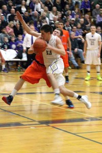 Junior Ross Dombrowski rushes down the court preparing to take a shot Jan. 24 against Graham- Kapowsin.