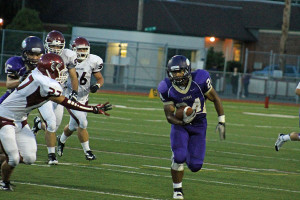 Junior Michael Fuller passes by the Falcon Defense.