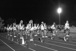 The cheer team takes a break from cheering during a home football game earlier this fall. Stunts performed at both practices and games like these are what prepared the girls for their competition this winter. 