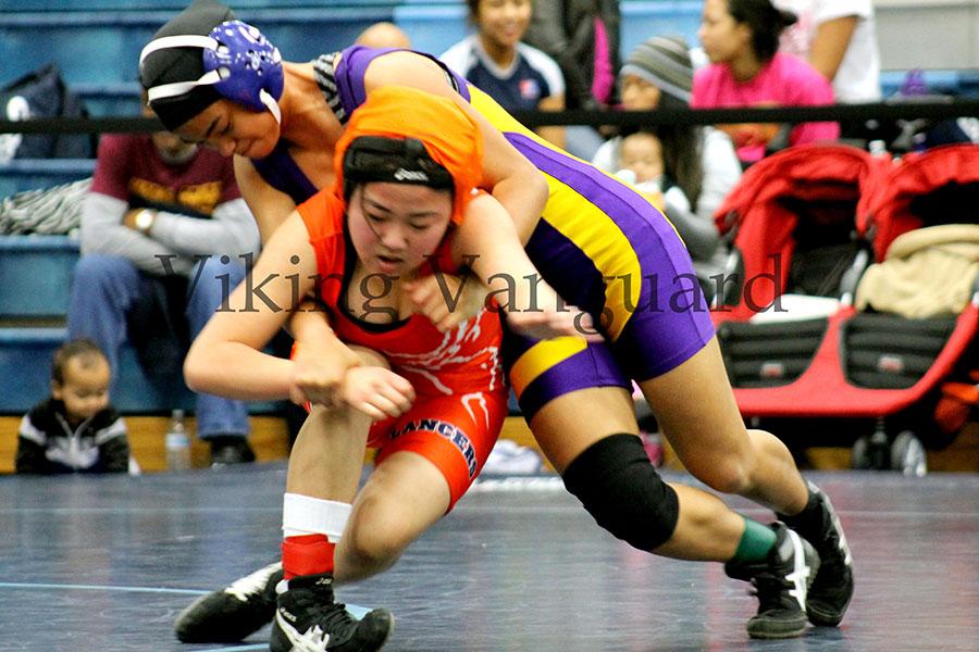 Sophomore Justine Tulaepa goes for a take down against her opponent from Lakes High School.