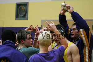 The Puyallup wrestling team huddles and puts “viks” up before the tournament starts.
