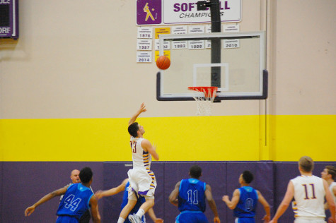 Senior Ross Dombrowski makes a basket, scoring two points for Puyallup. The boys basketball team lost to Curtis High School Jan. 20 with a score of 68-75 after going into overtime.