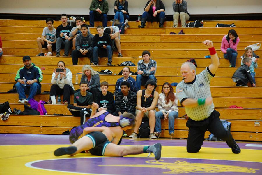 Senior Ryan Colkitt nearly pins his opponent. The wrestling team won 49-18 against Spanaway Lake High School Jan. 21. 