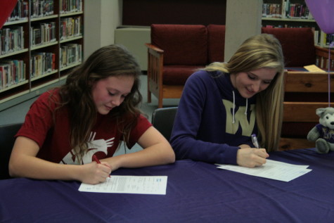 Liz Griffith and Jessica Udovich sign their letters of intent. 