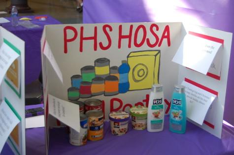HOSA students explain that the PHS HOSA Food Pantry benefits PHS students. The Health Occupation Students of America club held their annual spring health fair March 26.