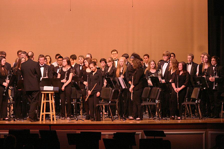 The Wind Ensemble stands up to be recognized after their performance. The Percussion and Wind Ensemble along with the Jazz, Concert and Symphonic Bands performed March 23 at the band concert held in the auditorium.