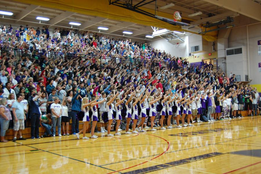 Students+display+a+symbol+of+school+spirit+through+the+Viking+horns+at+the+end+of+The+Star-Spangled+Banner+during+the+Sept.+19+assembly.+