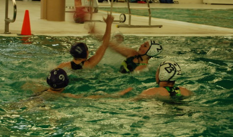 Junior Olivia Wood tries to block a shot from an opponent player. PHS girls Water Polo team went up against Emerald Ridge April 22. Puyallup won with a final score of 9-0. 