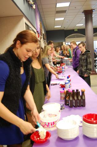 Seniors Katie Hawley and Sierra Molmen serve students ice cream and various toppings.  Leadership rewarded students that have a G.P.A. of 3.0 or higher with ice cream sundaes during both lunches April 29. 