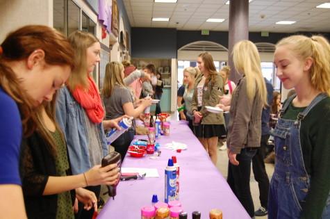 Students line up to exchange their color-coded tickets for sundaes. Leadership rewarded students that have a G.P.A. of 3.0 or higher with ice cream sundaes during both lunches April 29. 