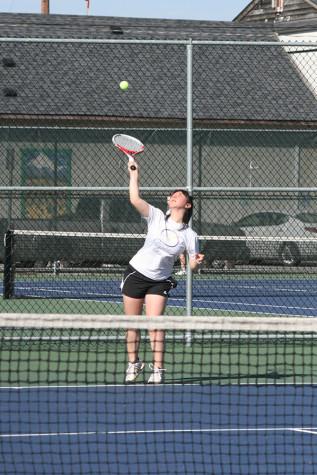 Senior Anna Flury serves the ball to her opponent. The girls tennis team faced Graham-Kapowsin High School March 26 and lost with a score of 1-4.