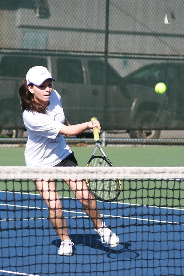 Senior Khiarah Eddington hits the ball as it comes from the opponent’s side. The girls tennis team faced Graham-Kapowsin High School March 26 and lost with a score of 1-4.