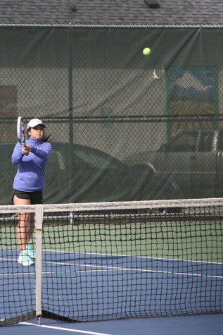 Junior Jordan Kim prepares to hit the ball as Spanaway Lake hits it over the net. The girls tennis team played against Spanaway Lake High School April 14 and won with a score of 4-1.