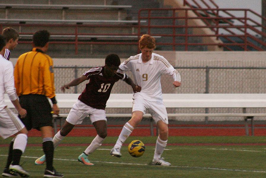 Junior Levi Woolley attempts to fight off a defender. The boys soccer team won against Bethel High School with a score of 7-0 April 21.