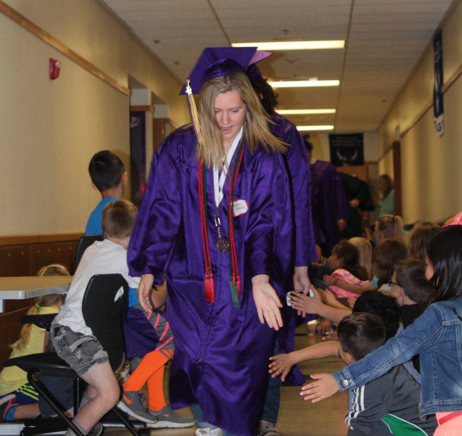 Senior Maddy Wheless walks the halls of Meeker Elementary June 17 after graduation practice. This process was repeated at other elementary schools throughout the district. 