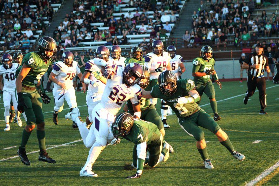 Senior Honore Thomas taking on multiple Emerald Ridge Jaguar defenders in their game against them Sept. 9. 