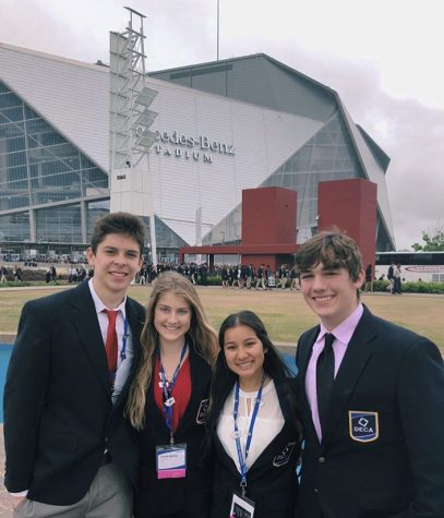  Ben Rodriguez, Carisa Steimle, Dharma Shah and Toren Herrick pose in front of the Mercedes-Benz Stadium at the national DECA competition in Atlanta, GA. 