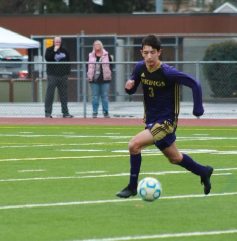 Dominic Saxowsky dribbling the ball up the field at a boys soccer game. Photo courtesy of Dominic Saxowsky. 
