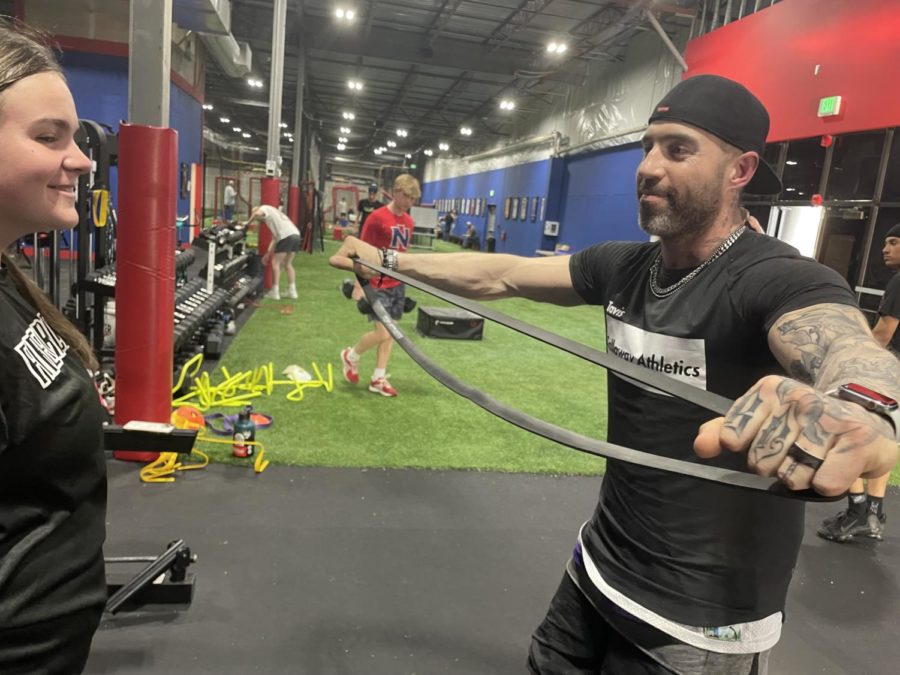 Travis Calloway works with Kate Havice on a workout. "I don't get sore as much anymore because I'm working out, I'm getting good recovery from softball,” Havice said. 