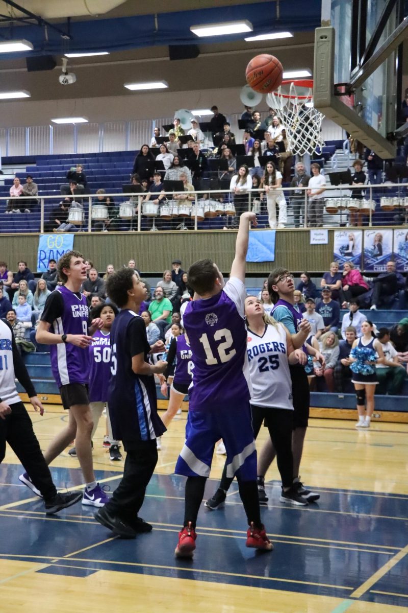 The Unified Basketball team scores a basket against your opponent, Rogers High School.