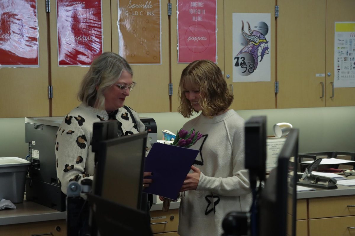 Senior Lola Woodburn receives her Washington State Journalist of the Year award and Robin Morris Memorial Scholarship from Glacier Peak High School yearbook adviser Annie Stone